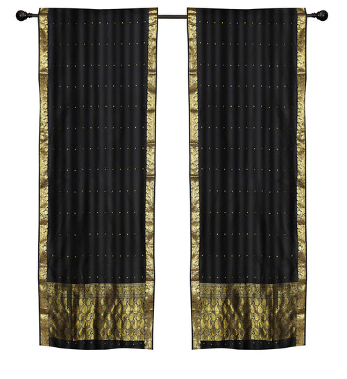 Black sari rod pocket curtains hung at a window