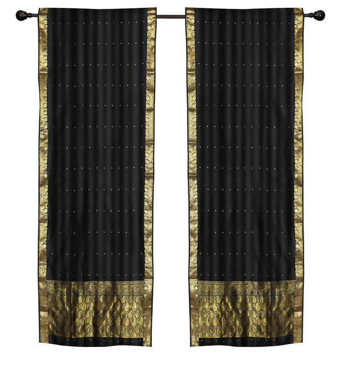 Black sari rod pocket curtains hung at a window