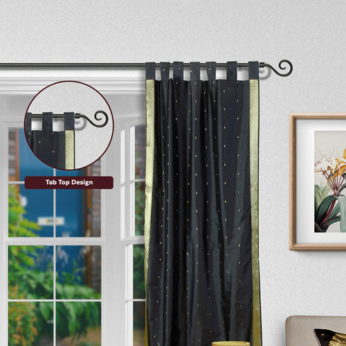 Black sari tab top curtains hung at a window
