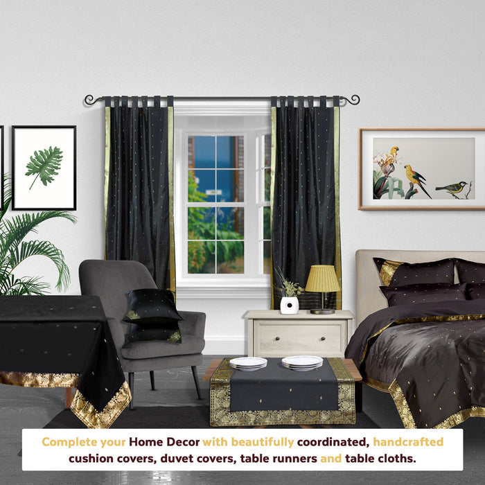 Black sari tab top curtains hung at a window