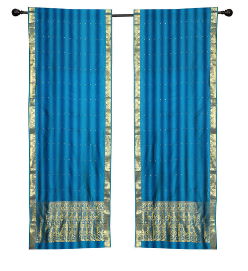 Blue sari rod pocket curtains hung at a window
