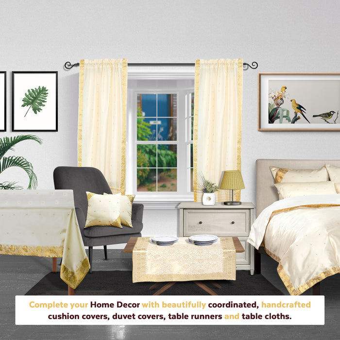 Cream sari rod pocket curtains hung at a window