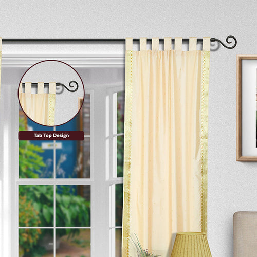 Cream sari tab top curtains hung at a window