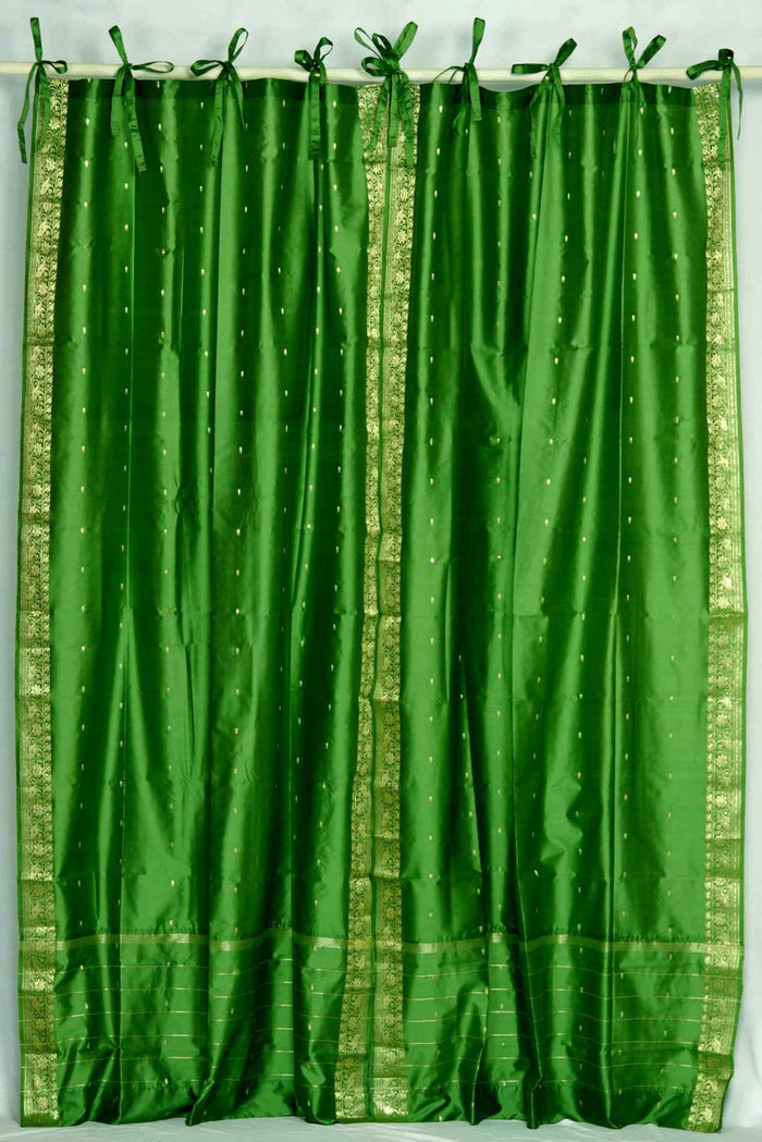Forest green sari tie top curtains hung at a window