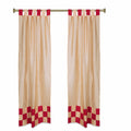 Gold sari tab top curtains hung at a window