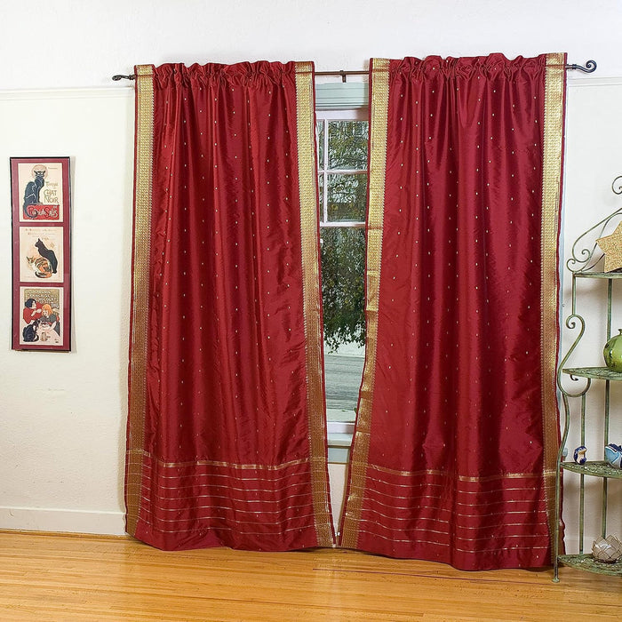 Maroon sari rod pocket curtains hung at a window