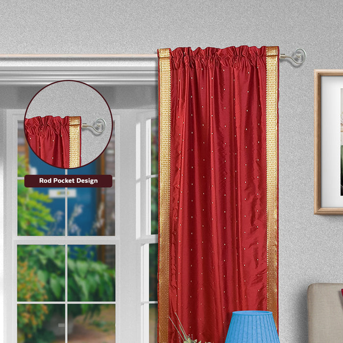 Maroon sari rod pocket curtains hung at a window