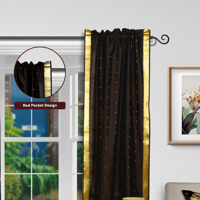 Black sari rod pocket curtains hung at a window