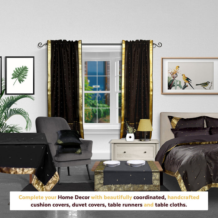 Black sari rod pocket curtains hung at a window