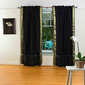 Black sari rod pocket curtains hung at a window