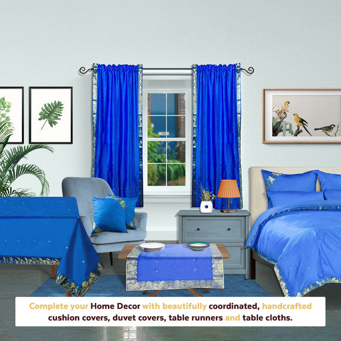 Blue sari rod pocket curtains hung at a window