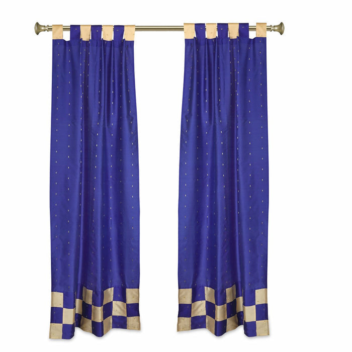 Blue sari tab top curtains hung at a window