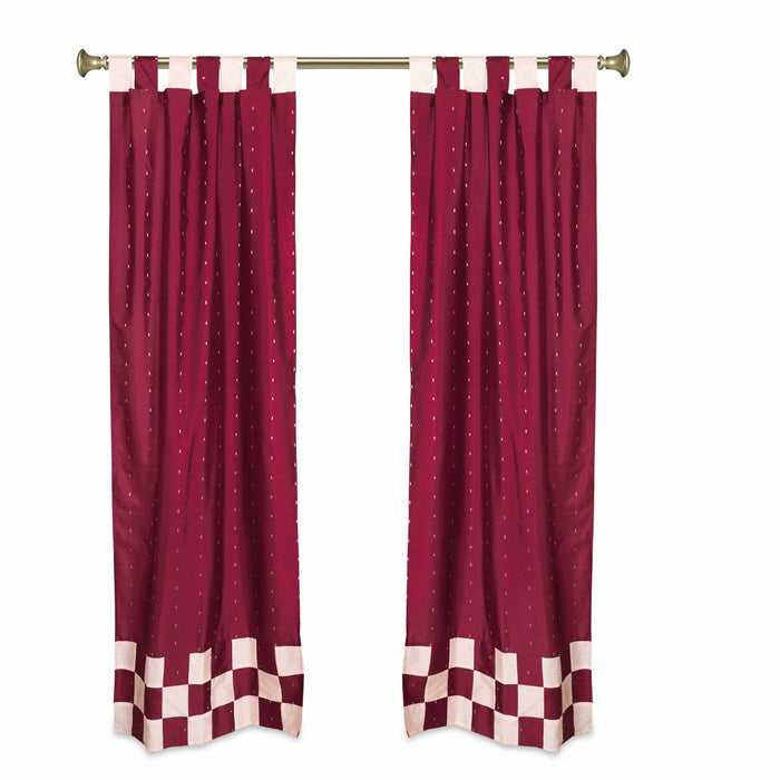 Maroon sari tab top curtains hung at a window