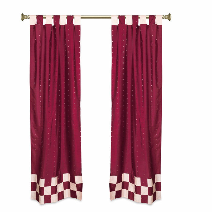 Maroon sari tab top curtains hung at a window
