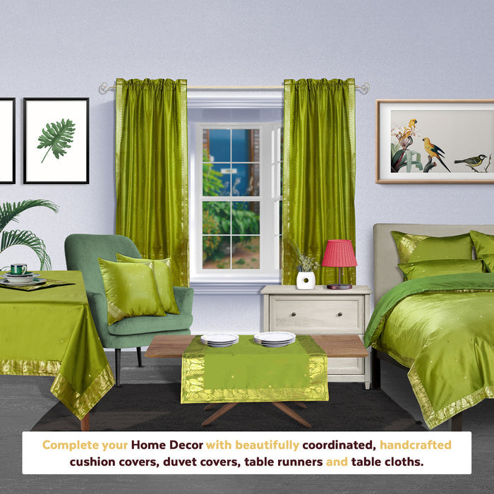 Olive green sari rod pocket curtains hung at a window