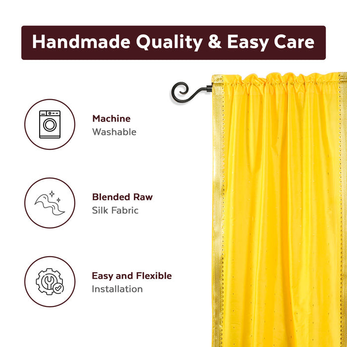 Yellow sari rod pocket curtains hung at a window