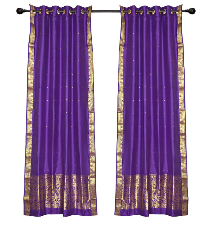 Purple sari ring top curtains hung at a window
