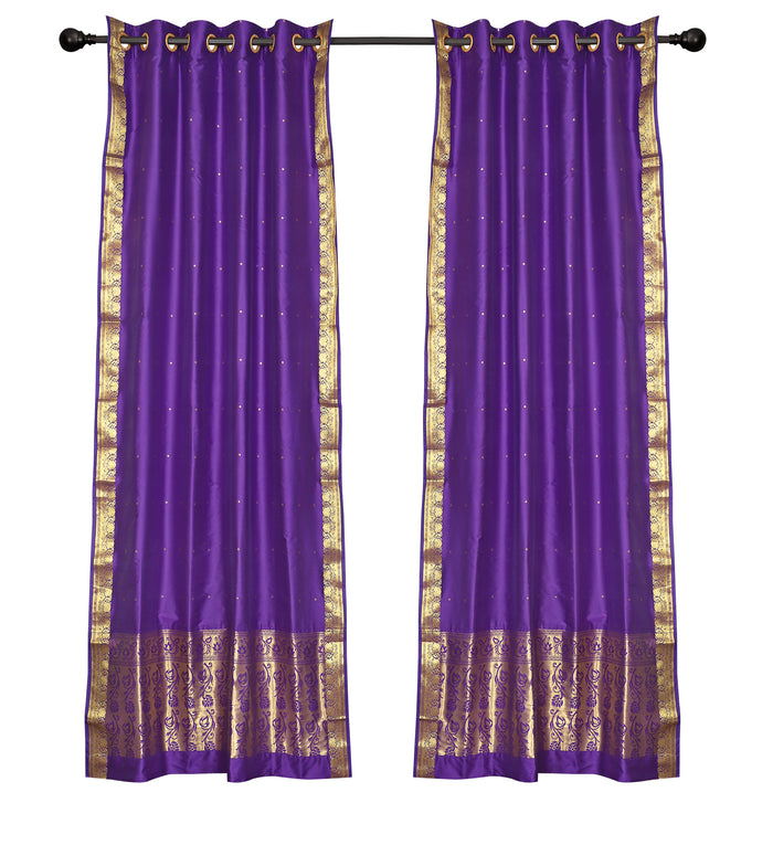 Purple sari ring top curtains hung at a window
