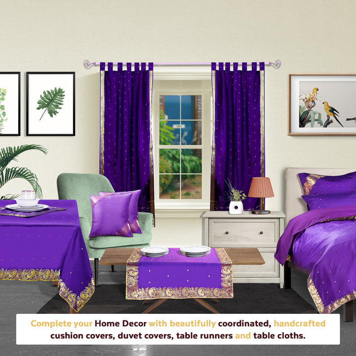 Purple sari tab top curtains hung at a window