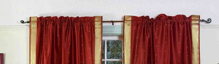 Rust sari rod pocket curtains hung at a window