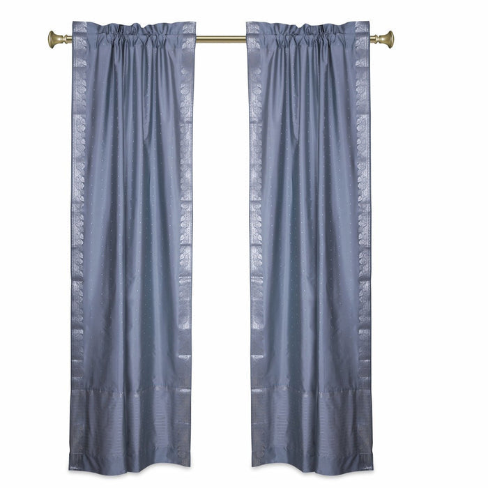 Silver sari rod pocket curtains hung at a window