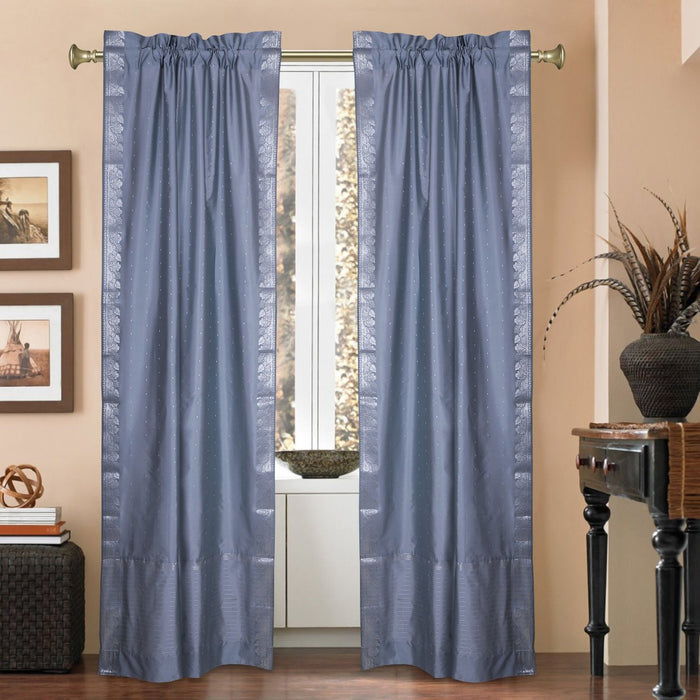 Silver sari rod pocket curtains hung at a window