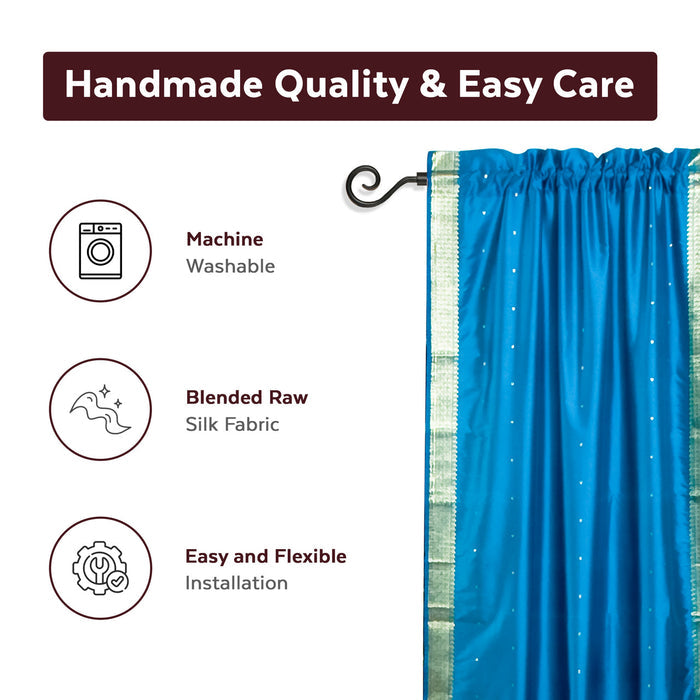 Turquoise sari rod pocket curtains hung at a window