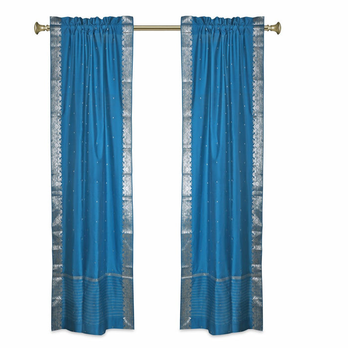 Turquoise sari rod pocket curtains hung at a window