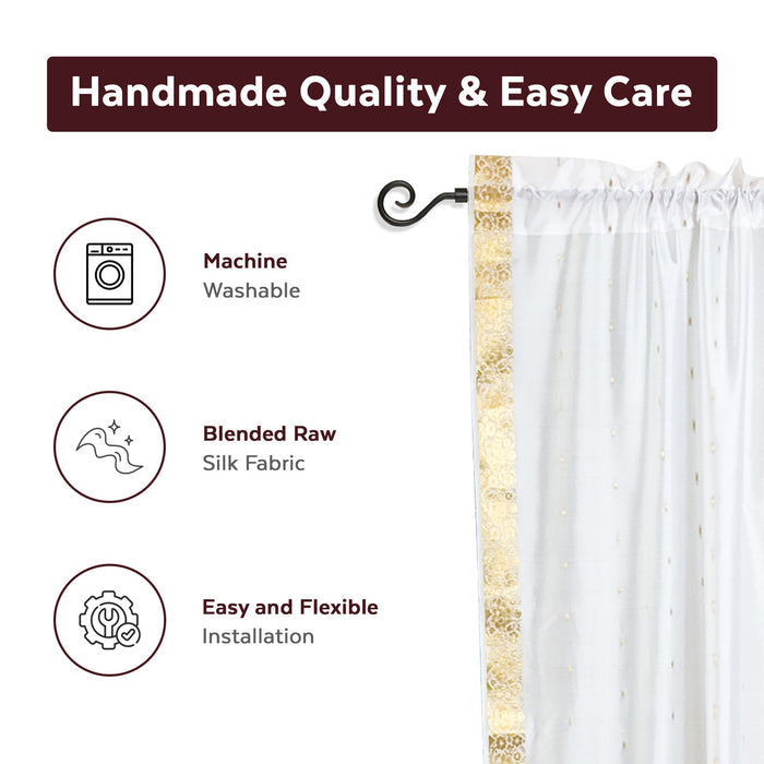 White sari rod pocket curtains hung at a window