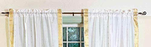 White sari rod pocket curtains hung at a window