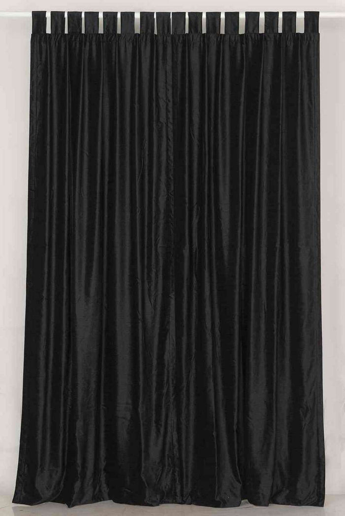 Black velvet tab top curtains hung at a window