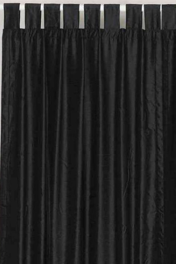 Black velvet tab top curtains hung at a window