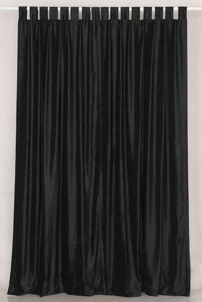 Black velvet tab top curtains hung at a window