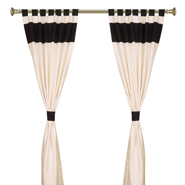Cream raw silk tab top curtains hung at a window