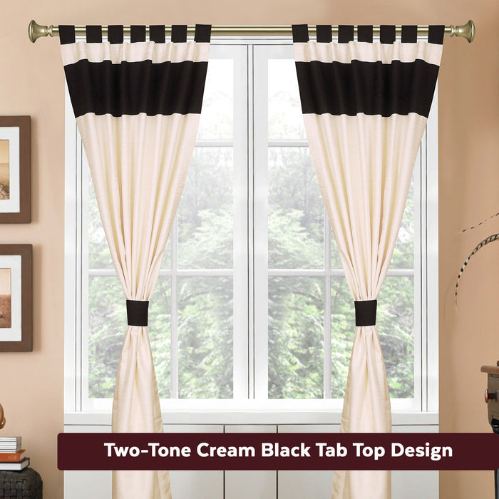 Cream raw silk tab top curtains hung at a window