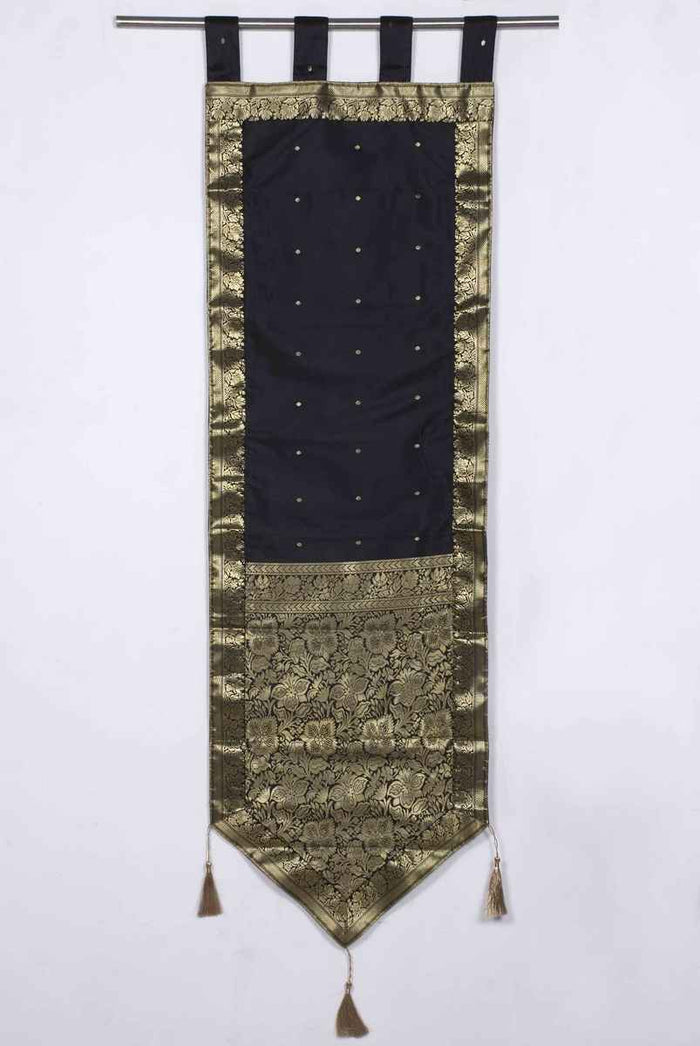 Black sari wall hanging displayed on a wall