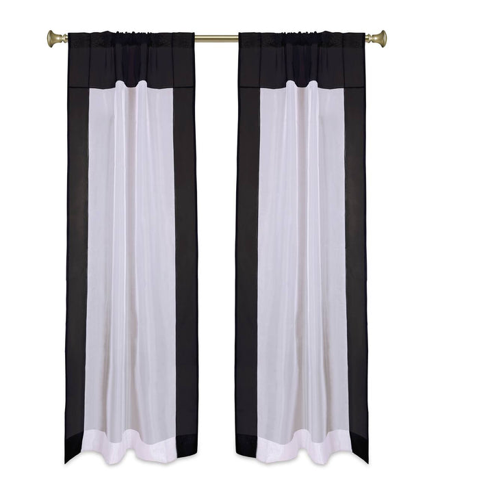 Black sheer tissue rod pocket curtains hung at a window