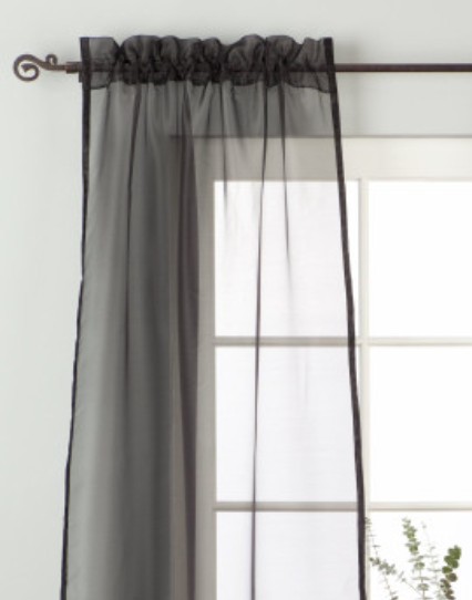 Black sheer tissue rod pocket curtains hung at a window