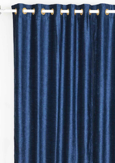 Navy blue velvet grommet top curtains hung at a window