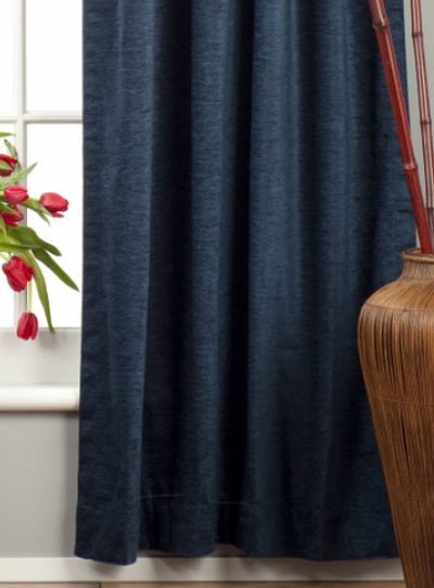 Navy blue velvet rod pocket curtains hung at a window