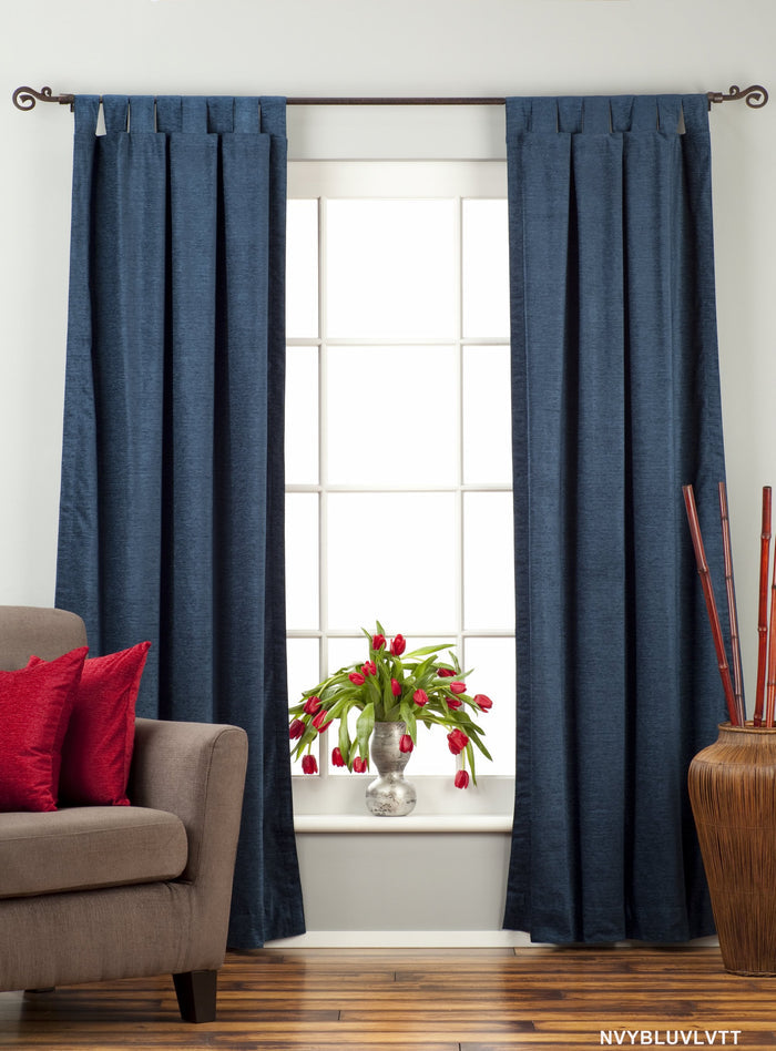 Navy blue velvet tab top curtains hung at a window
