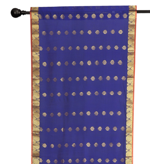 Blue sari rod pocket curtains hung at a window