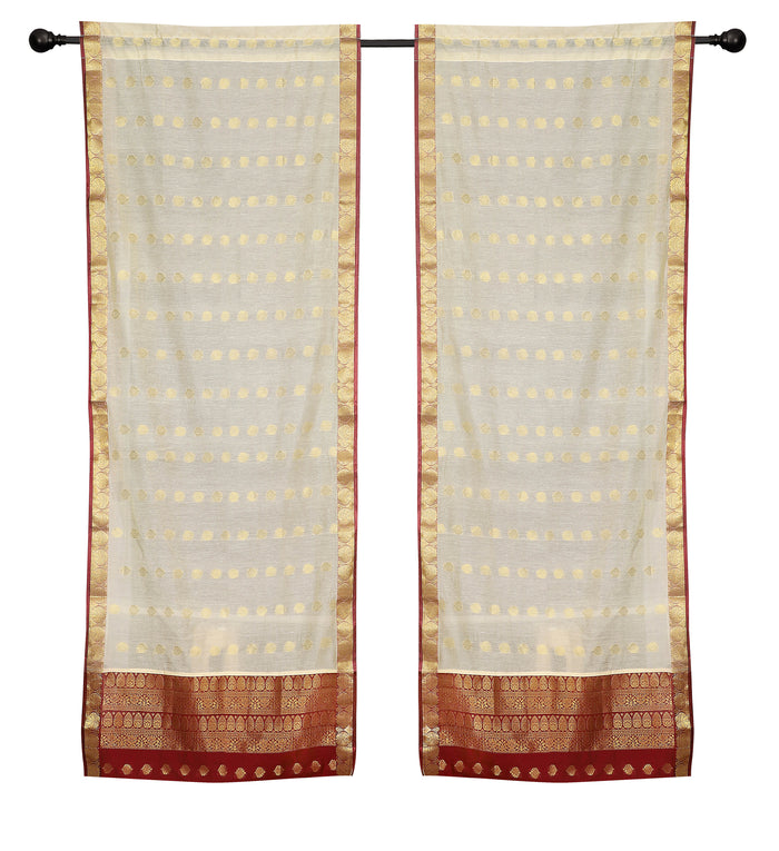 Cream sari rod pocket curtains hung at a window