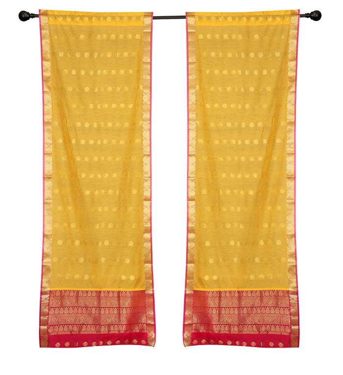 Yellow sari rod pocket curtains hung at a window