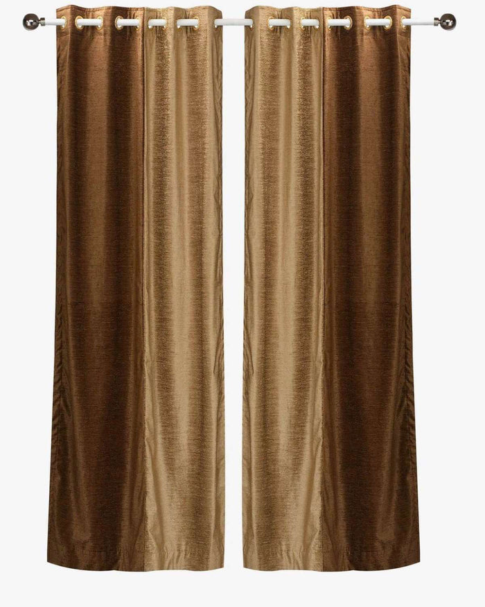 Taupe velvet ring top curtains hung at a window