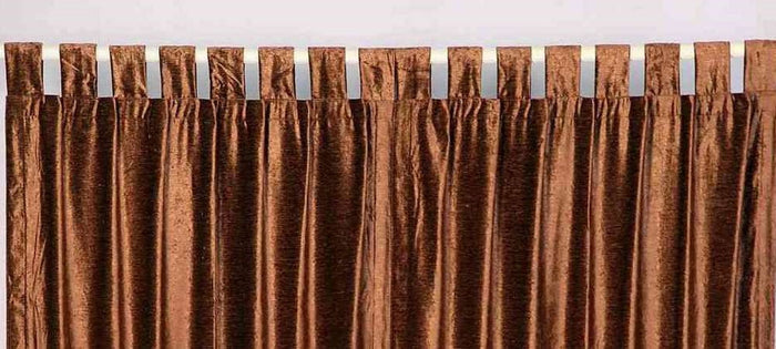 Brown velvet tab top curtains hung at a window
