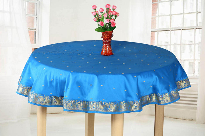 Cool blue sari tablecloth laid on a dining table