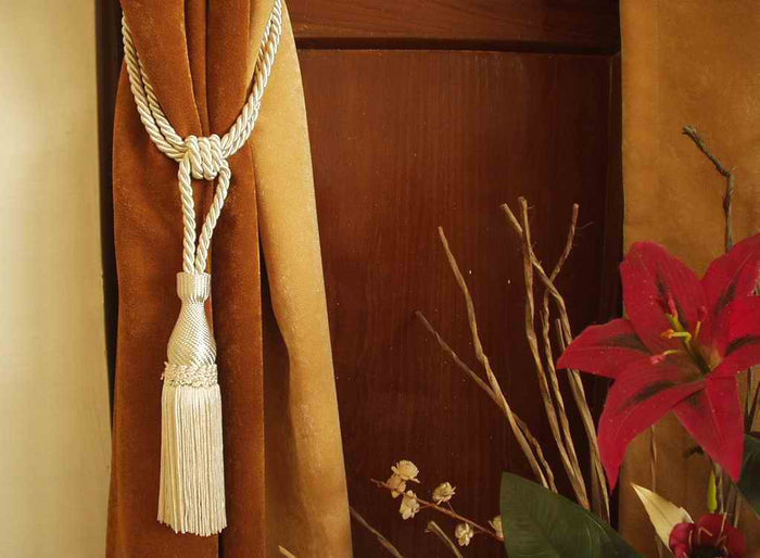 Cream sari curtain tiebacks holding a panel open