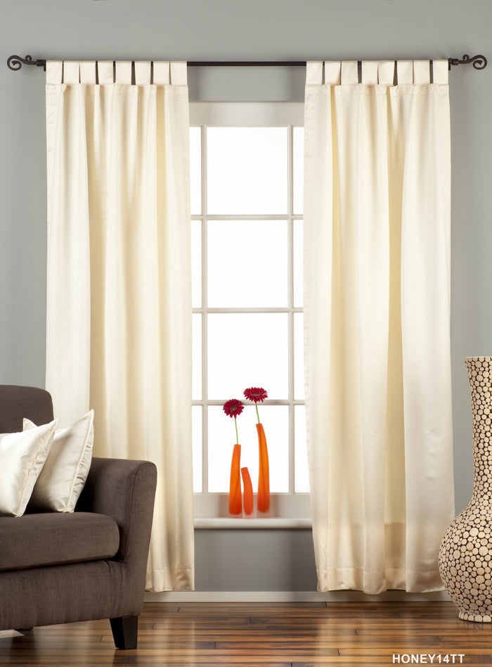 Cream sari tab top curtains hung at a window