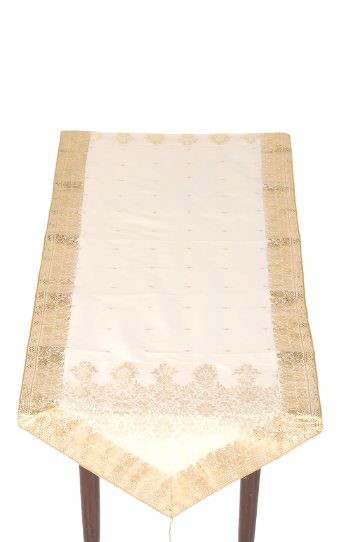 Cream silk table runner running down a dining table